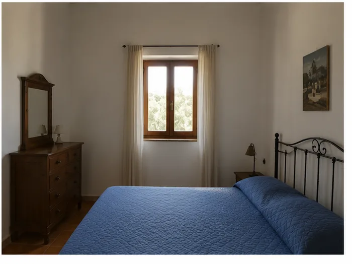 Bedroom interior in a Sicilian country home, with window overlooking the olive grove
