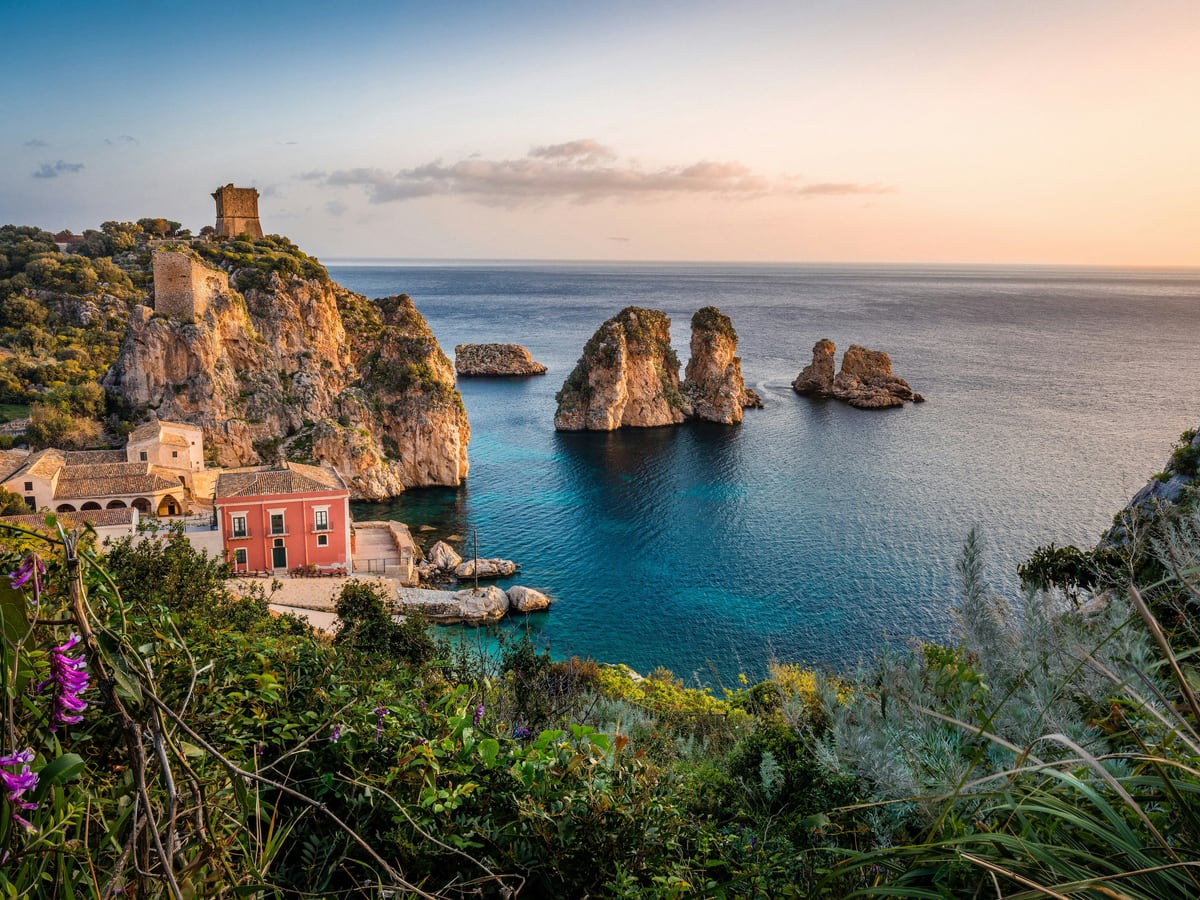 The Tonnara di Scopello and its sea stacks at sunset, on the Trapani Province coastline